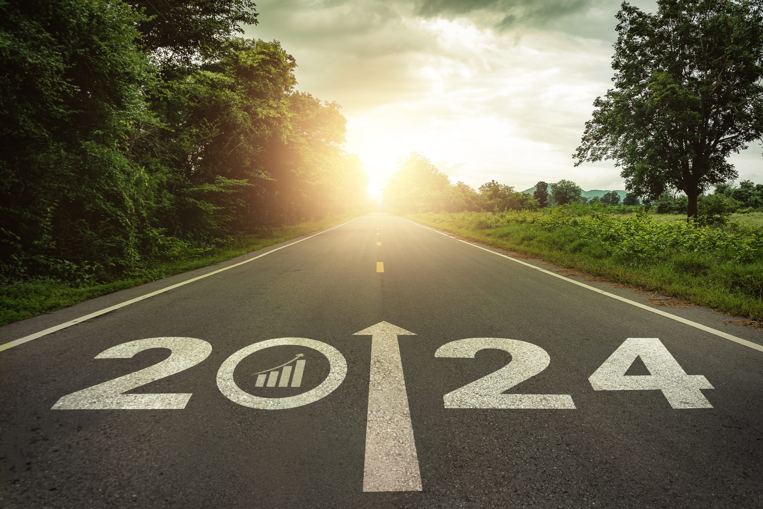 2024 Goal plan action, Business target and growth strategy. Business annual plan and development for achieving goals and success. 2024 written on the road in the middle of asphalt road with at sunset.